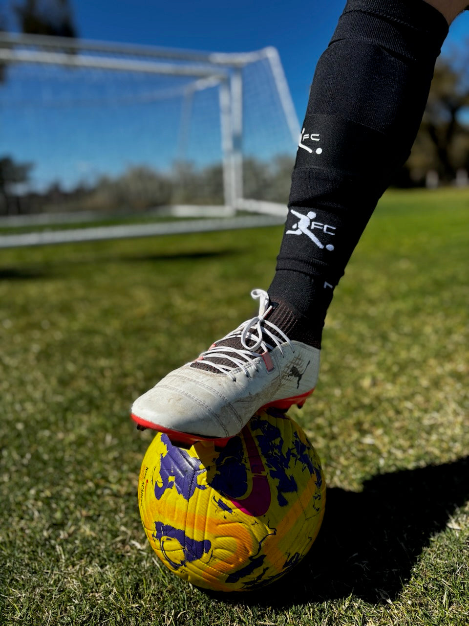 Black footless socks, action image, soccer socks